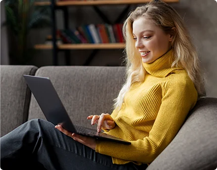 beautiful young woman working from home laptop sitting sofa living room