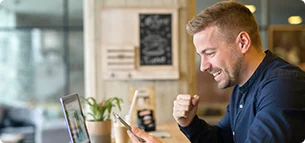 happy freelancer with tablet laptop computer coffee shop 1